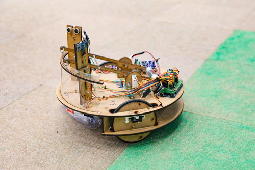 During the STI robot competition, five teams of three master students from different sections of the STI faculty have to design, build and program a cleaning robot. The realized robots must be able to autonomously move in a 64 m² arena that features obstacles and different terrains, while detecting and gathering empty PET bottles, which should then be brought to a specific recycling area. The competition is implemented as a regular semester project during the spring semester.