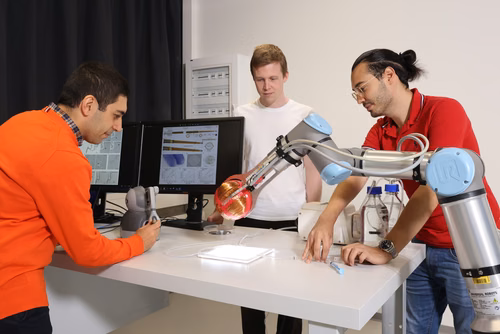 EPFL researchers have invented a remarkably small and ultraflexible neurovascular microcatheter. Powered by blood flow, it can safely navigate the most intricately branched arteries in a matter of seconds. (Left-right): Selman Sakar, Julian Raub, and Mehdi Ali Gadiri