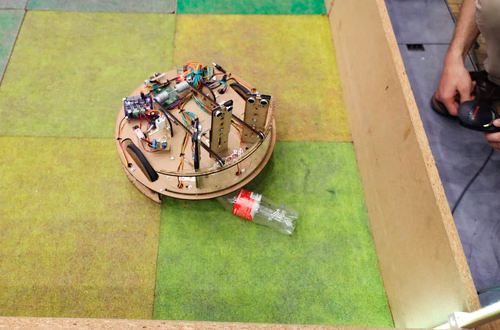 During the STI robot competition, five teams of three master students from different sections of the STI faculty have to design, build and program a cleaning robot. The realized robots must be able to autonomously move in a 64 m² arena that features obstacles and different terrains, while detecting and gathering empty PET bottles, which should then be brought to a specific recycling area. The competition is implemented as a regular semester project during the spring semester.